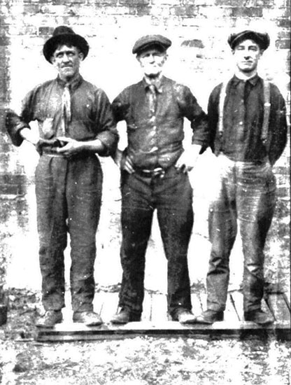 Un homme portant un chapeau et deux hommes portant une casquette.